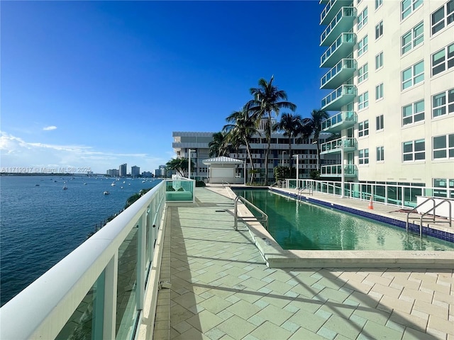 view of pool with a water view