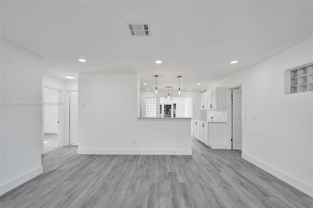 unfurnished living room with light wood-type flooring