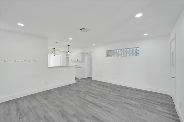 unfurnished living room featuring light wood-type flooring