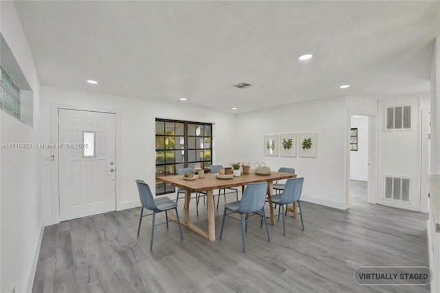 dining space featuring light wood-type flooring