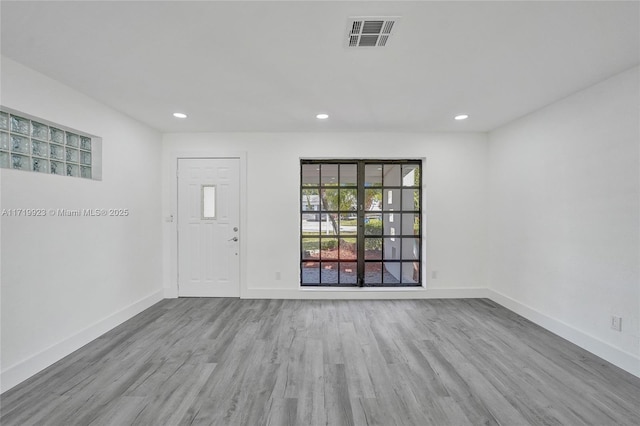 interior space with recessed lighting, visible vents, baseboards, and wood finished floors