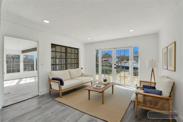 living room with baseboards, wood finished floors, and recessed lighting