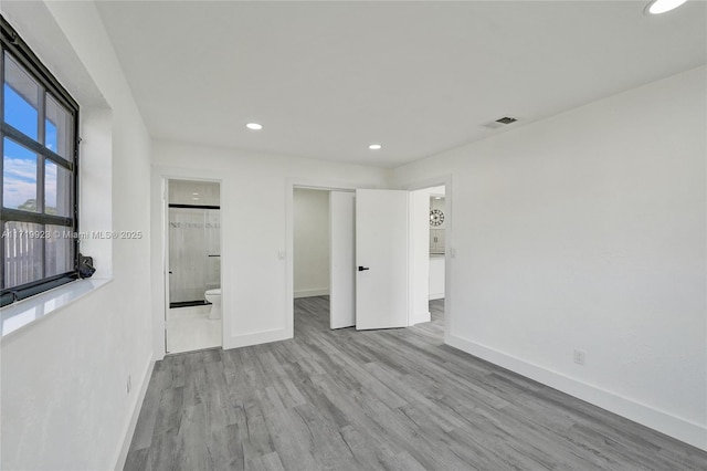 unfurnished bedroom featuring visible vents, baseboards, wood finished floors, a closet, and recessed lighting