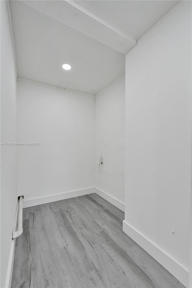 unfurnished room featuring wood finished floors and baseboards