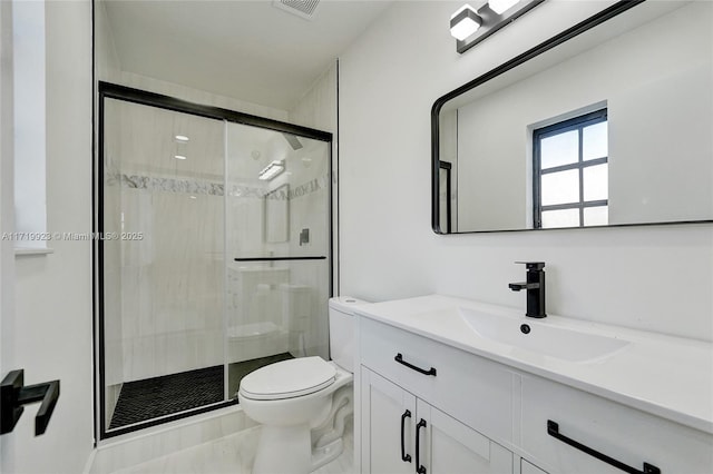 bathroom featuring vanity, an enclosed shower, and toilet