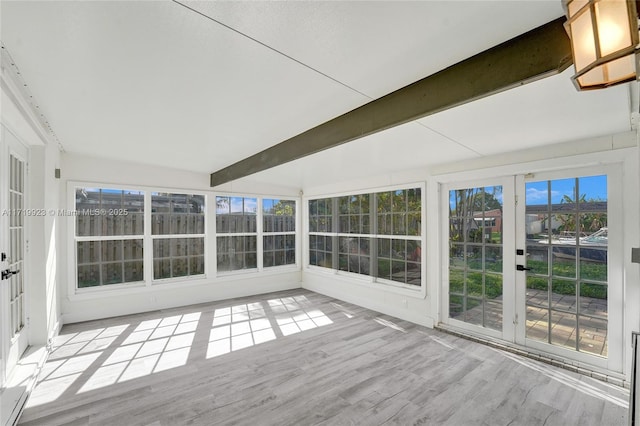 unfurnished sunroom with beamed ceiling