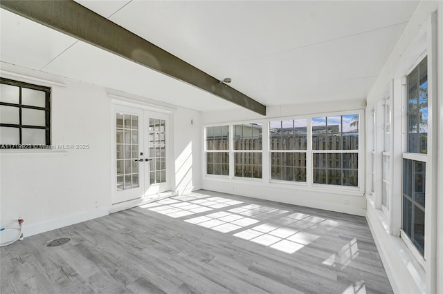 unfurnished sunroom with french doors and beamed ceiling