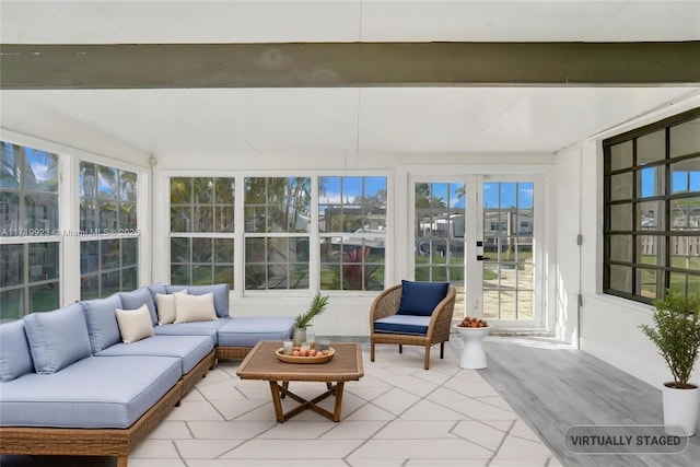 sunroom featuring beam ceiling