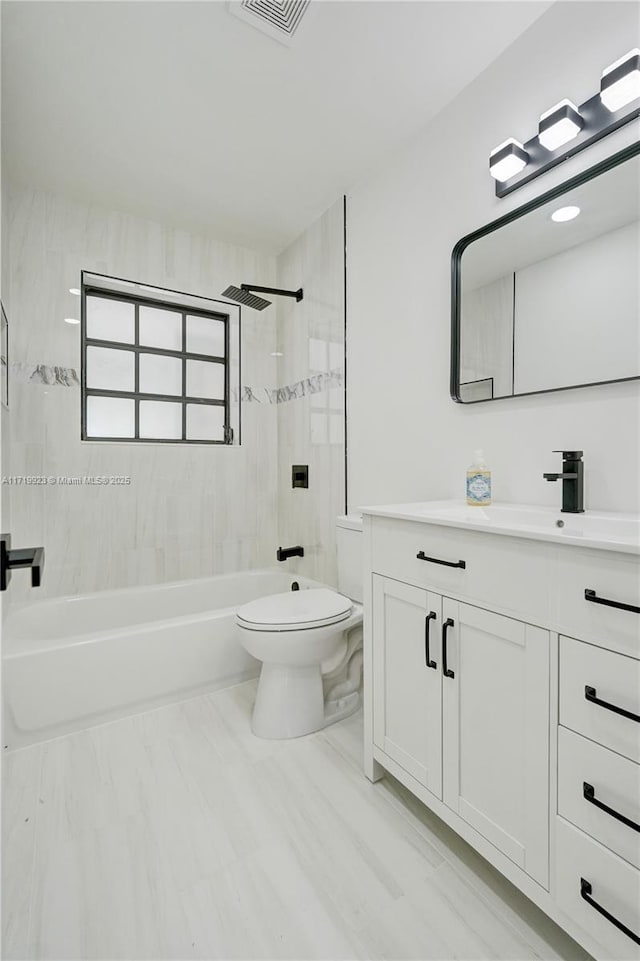 bathroom with visible vents, shower / bathing tub combination, vanity, and toilet