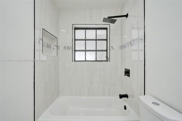 bathroom featuring shower / bath combination and toilet