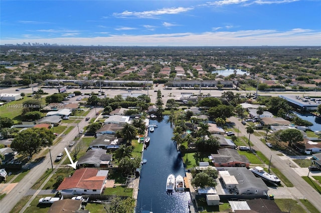 drone / aerial view with a water view and a residential view