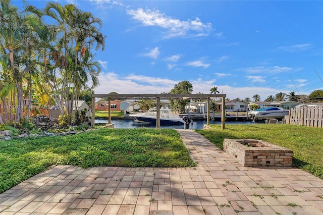 view of patio with a water view and a boat dock