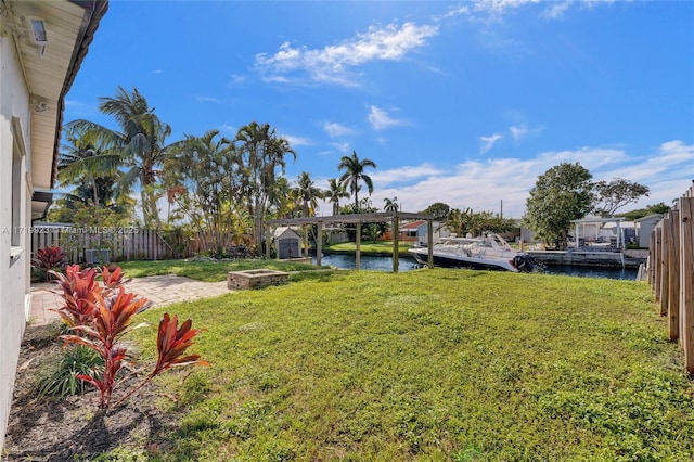 view of yard with a water view and a pergola