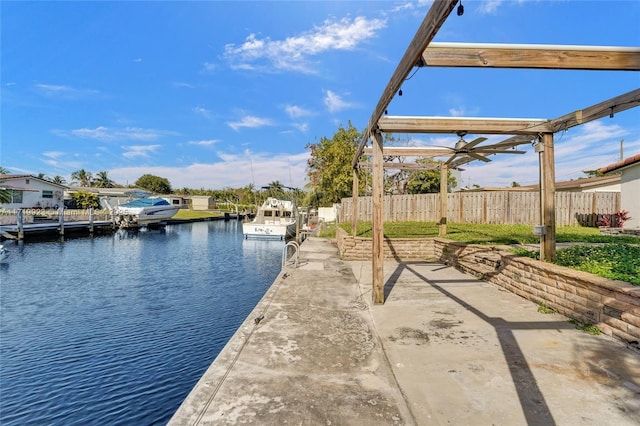 exterior space with a water view and fence