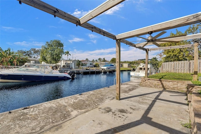 view of patio / terrace featuring a boat dock, a water view, and fence