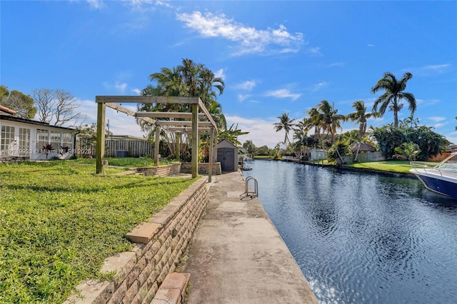 exterior space featuring a yard, a water view, and fence