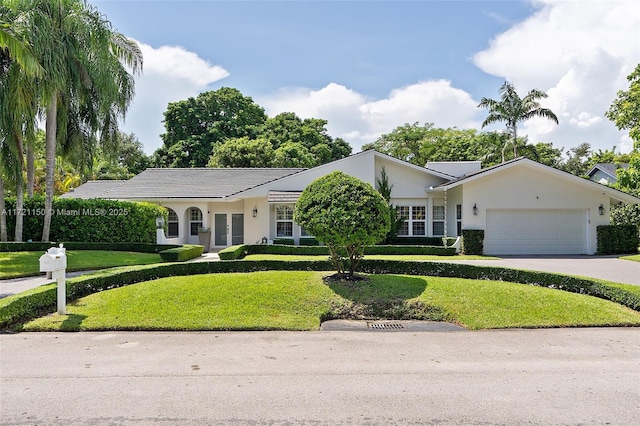 single story home with a front lawn and a garage