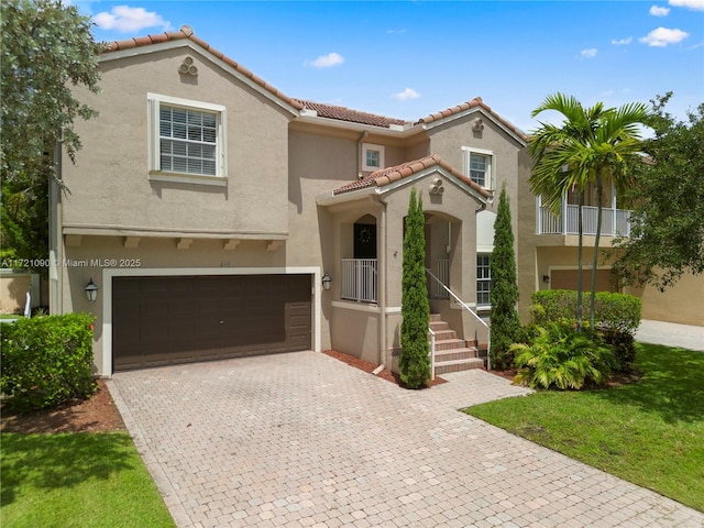 mediterranean / spanish-style house with a garage