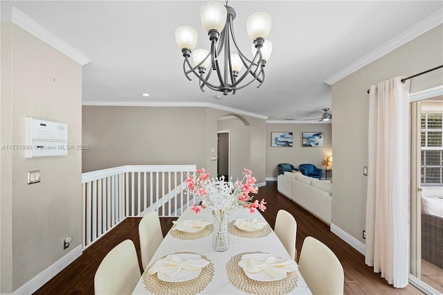 dining area featuring crown molding, ceiling fan with notable chandelier, and dark hardwood / wood-style floors