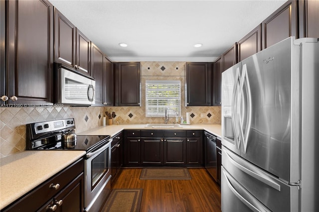 kitchen featuring dark brown cabinets, dark hardwood / wood-style flooring, stainless steel appliances, and sink