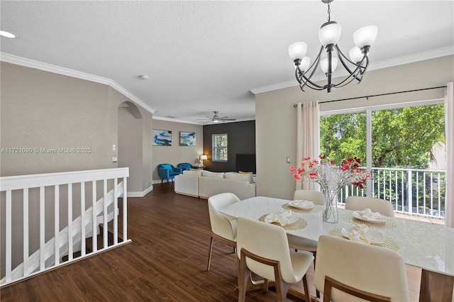 dining space featuring ceiling fan with notable chandelier, dark hardwood / wood-style flooring, and crown molding