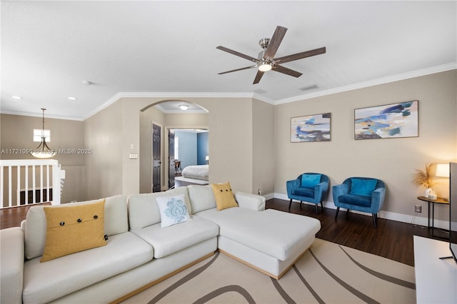 living room featuring crown molding, ceiling fan, and dark hardwood / wood-style floors