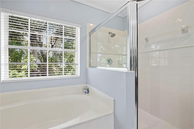 bathroom with a healthy amount of sunlight, crown molding, and plus walk in shower