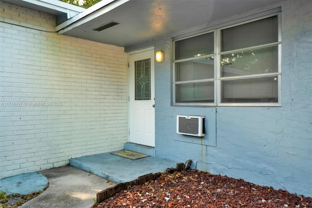 doorway to property featuring a wall mounted air conditioner