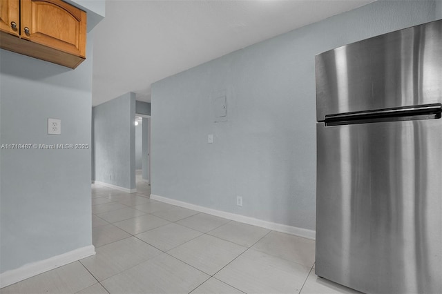 kitchen featuring stainless steel fridge and light tile patterned flooring