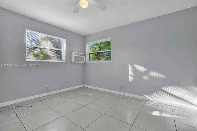 tiled empty room with a wall unit AC and ceiling fan