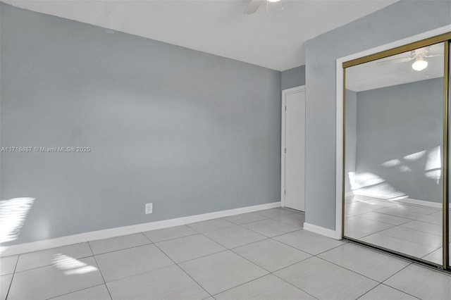 unfurnished bedroom with ceiling fan, a closet, and light tile patterned floors