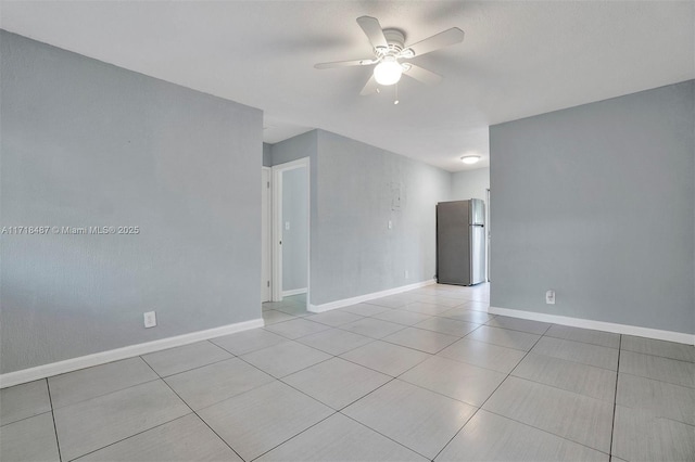 unfurnished room featuring ceiling fan and light tile patterned floors