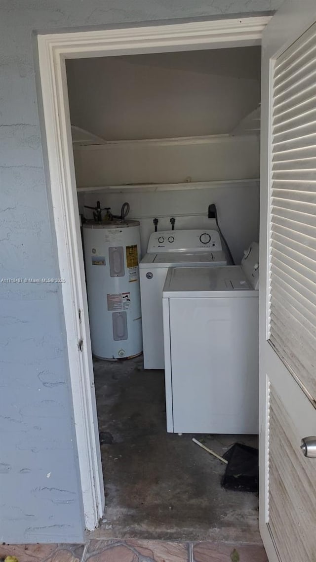 clothes washing area featuring independent washer and dryer and water heater