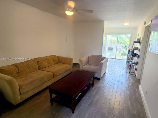 living room featuring ceiling fan and dark wood-type flooring