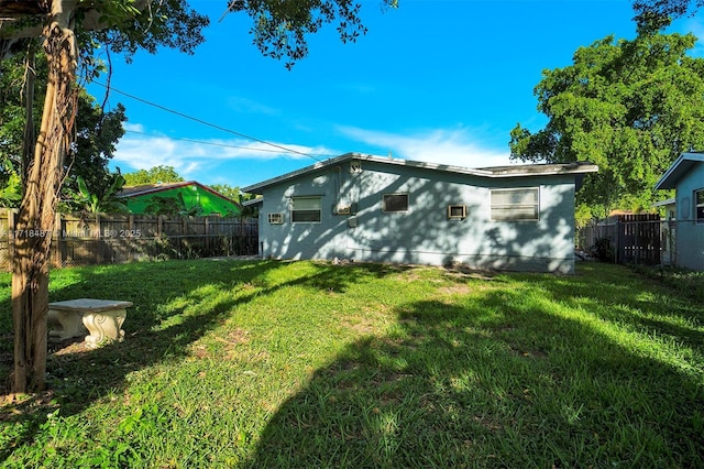 rear view of house featuring a yard