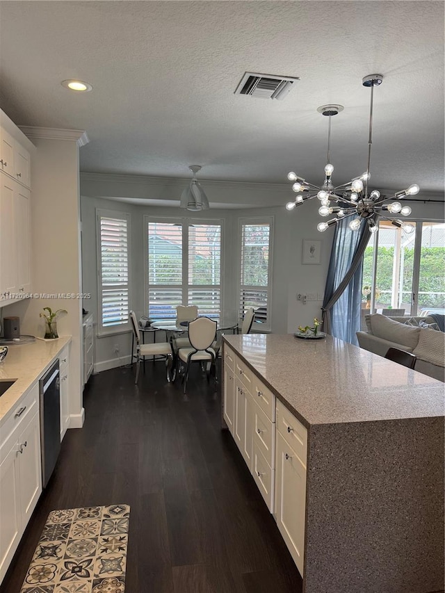 kitchen with white cabinetry, decorative light fixtures, a center island, and dishwasher