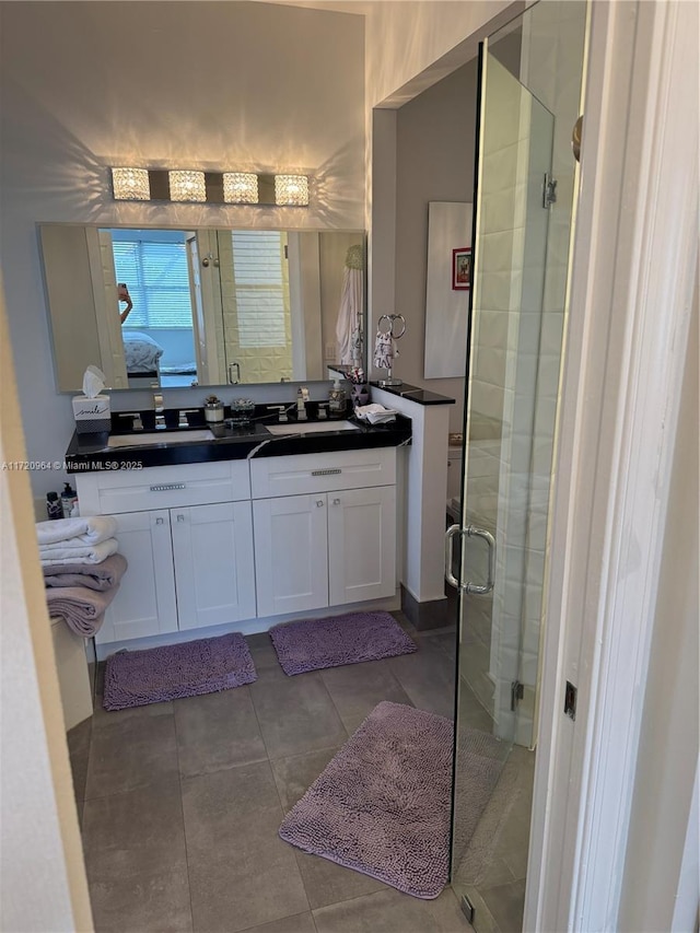 bathroom with vanity and a shower with door