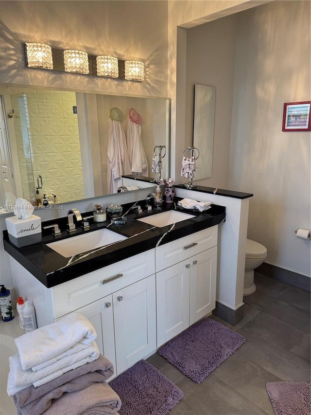 bathroom featuring vanity, toilet, and walk in shower