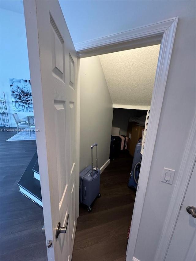 stairs featuring hardwood / wood-style floors and a textured ceiling