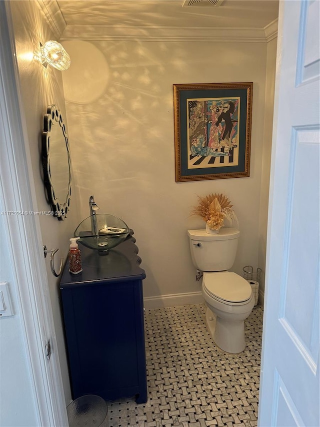 bathroom featuring ornamental molding, vanity, and toilet