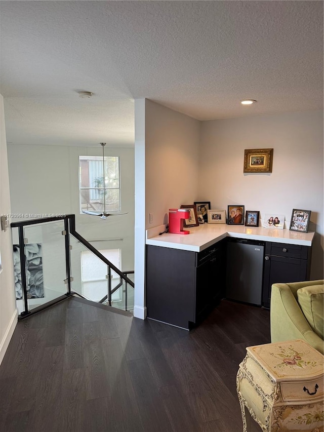 kitchen featuring dark wood-type flooring and a textured ceiling