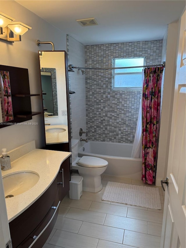 full bathroom featuring shower / tub combo, vanity, tile patterned floors, and toilet