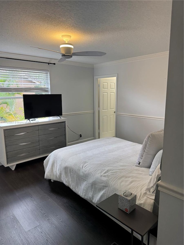 bedroom with ornamental molding, dark wood-type flooring, and a textured ceiling