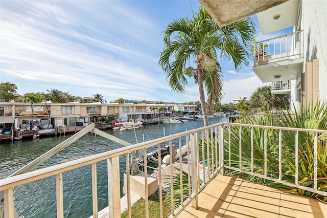 balcony with a boat dock and a water view