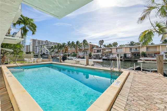 view of swimming pool featuring a water view