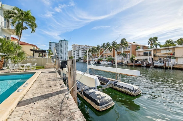 view of dock featuring a water view and a community pool