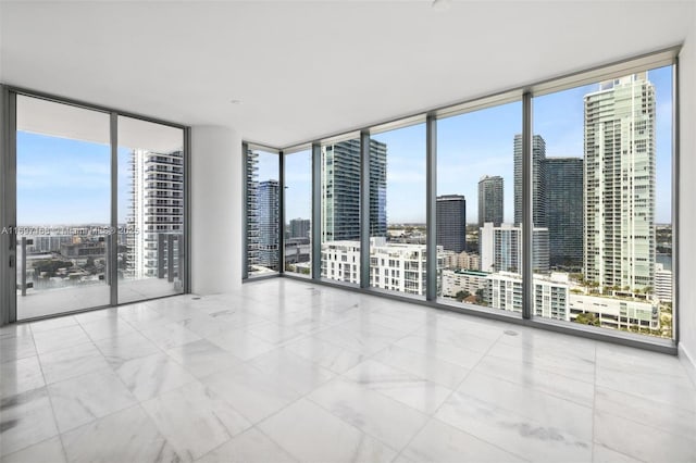 spare room with floor to ceiling windows and plenty of natural light