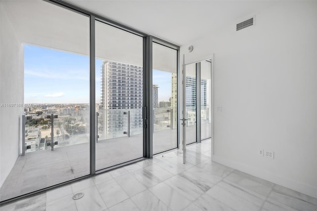 unfurnished room featuring expansive windows