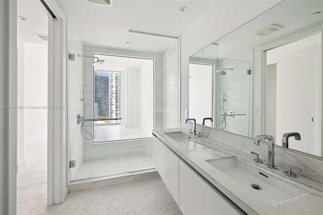 bathroom featuring tile patterned flooring, vanity, and a shower with shower door