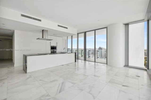 interior space featuring expansive windows and sink